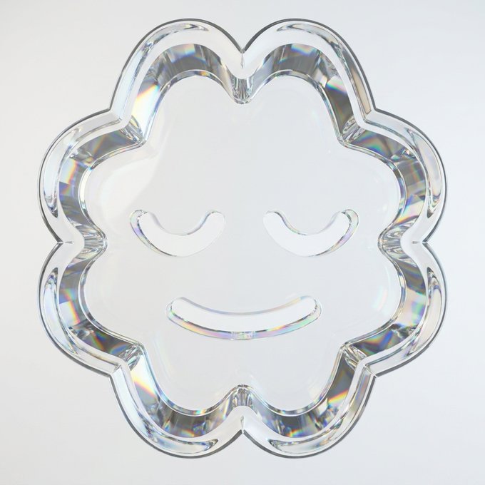 A clear acrylic flower-shaped dish or mirror tray featuring a serene closed-eye smiley face design reflects prismatic rainbow light on a white background.