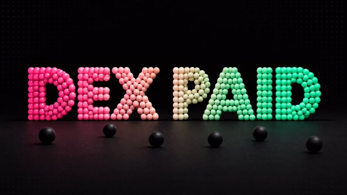 The text 'IDEIPAD' spelled out in colorful candy-like spheres (pink, white, and green) on a dark surface, with several black spheres in the foreground.