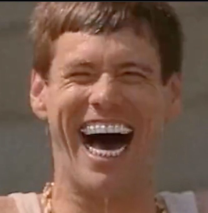 A man with short brown hair laughs heartily with his mouth wide open, wearing a gold chain and white tank top. The image captures a candid, joyful moment that aligns with the post's celebratory tone about the "lil Lloyd" token's growing popularity, as the laughter mirrors the excitement of an emerging "takeover" on social media.