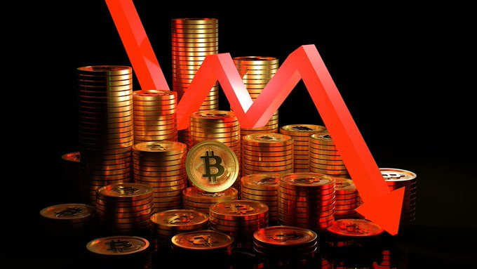 The image features a close-up view of a large stack of gold coins, including a prominent Bitcoin coin amongst them. The coins are scattered around in various sizes, with some appearing larger than others. A red arrow pointing downwards indicates that the Bitcoin value has been falling rapidly over time, and the overall sentiment surrounding this trend is one of fear and concern among traders who have experienced significant losses. The post seems to be discussing how Bitcoin's market behavior reflects wider issues within the cryptocurrency space and broader financial markets.