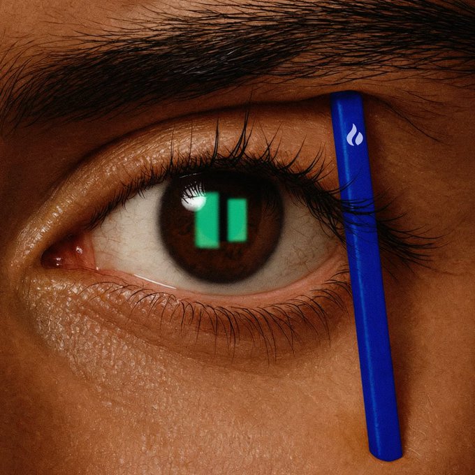 Close-up of a brown eye reflecting a green pause symbol in the pupil, with a blue Hydro Flask water bottle positioned vertically alongside the eye.