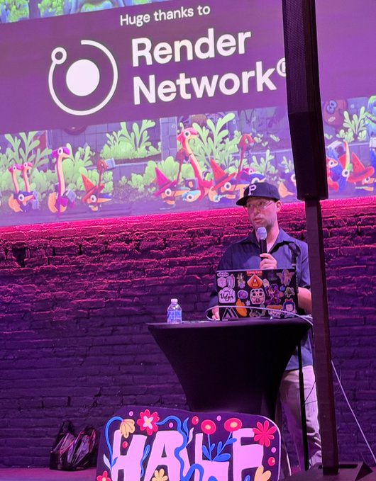 A speaker stands at a podium presenting at the @HalfRezChicago event, with a large screen behind him thanking Render Network and displaying colorful, stylized artwork. The branded signage for "Half Rez" is visible on the podium and floor, connecting to the recap mentioning David Meller and Blake Kathryn's discussion of how Render Network supports their filmmaking and immersive world-building work.