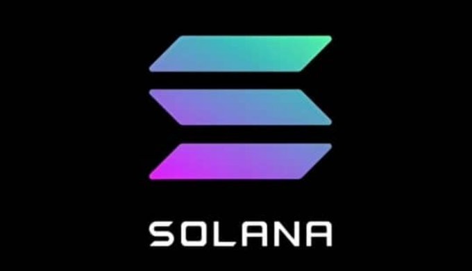 The image displays the Solana logo, featuring three stacked gradient bars in green, blue, and purple above the "SOLANA" text on a black background, visually representing the blockchain network discussed in the post.
