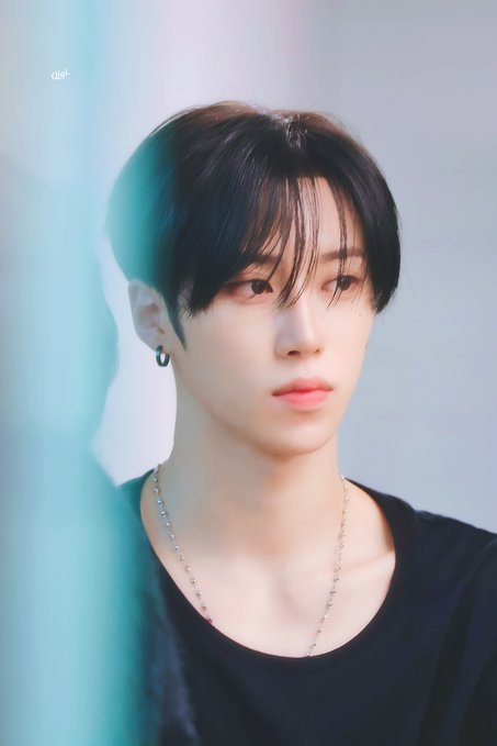 A close-up portrait of a young man with dark hair and bangs, wearing a black shirt and silver chain necklace, with soft blue-green lighting highlighting the side of his face. The caption "260710 ICN #아르노 #ARNO" suggests this is Arno, likely captured on July 10, 2026, at Incheon.