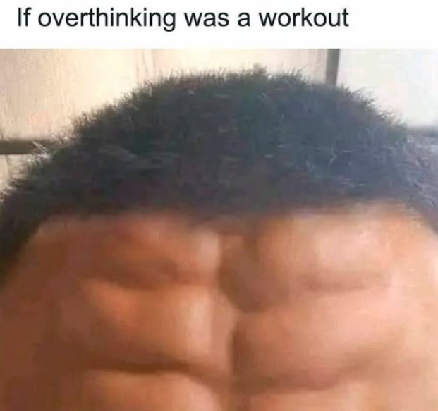 The image features a close-up view of someone's head, with their hair styled in a messy bun or ponytail. The person has a muscular torso, which appears to be a hairy backside. The background of the image is blurred, making it difficult to determine what else might be present in the scene.