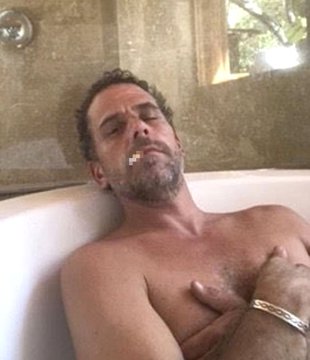 The image shows a shirtless middle-aged man with dark hair and stubble reclining in a bathtub, laughing with his eyes closed, wearing a silver bracelet on his wrist. The accompanying post appears to reference a cryptocurrency ($LAPTOP) that experienced a massive crash, suggesting the man depicted is enjoying or celebrating the financial losses suffered by investors who bought into the coin.
