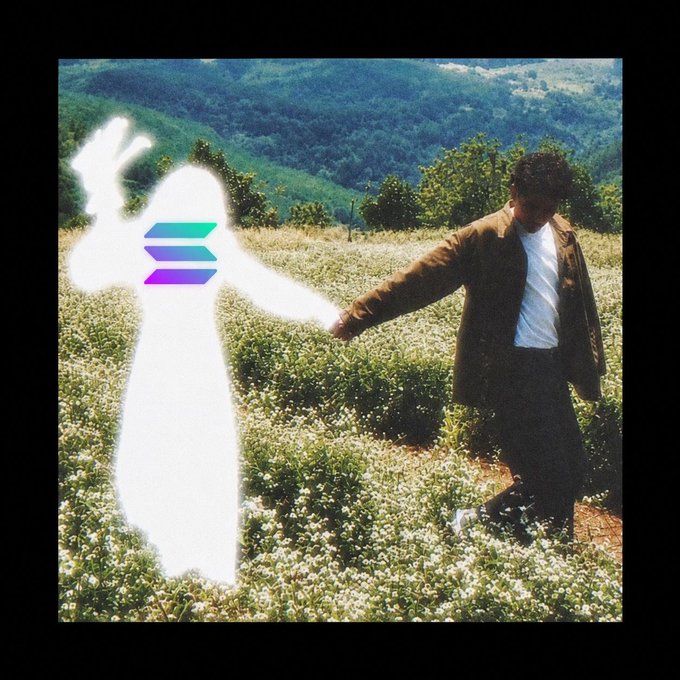 A person in a suit reaches out to hold hands with a glowing white, ghost-like figure overlaid with the Solana logo in a flower-filled field with mountains in the background, symbolizing a lasting bond or partnership. The ethereal connection visually reinforces the sentiment "I will never leave Solana."