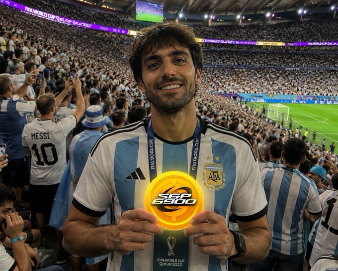 The image features a man holding up a disc with the words "Coca Cola" written on it, likely from the World Cup games. The man appears to be smiling for the camera while holding the disc. The surrounding crowd suggests that this is an exciting event, and the man's presence in front of the crowd indicates his support or involvement in promoting the brand during the game.