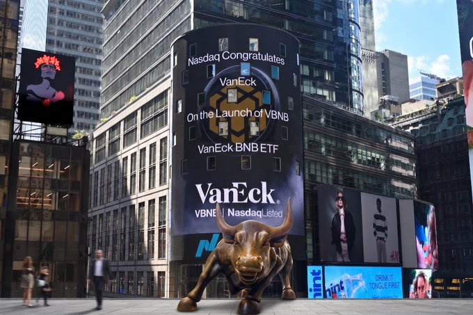 The image features a large bull statue located in New York City's financial district, surrounded by tall buildings. The bull statue is positioned near a billboard advertising the Van Eck Bitcoin ETF (VBNB). A person can be seen walking past the bull statue on the sidewalk.