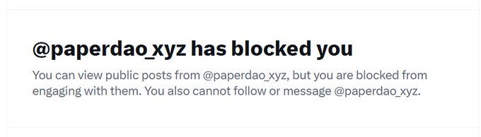 A notification screen reading '@paperdao_xyz has blocked you' with text explaining that public posts can be viewed but engagement is restricted.
