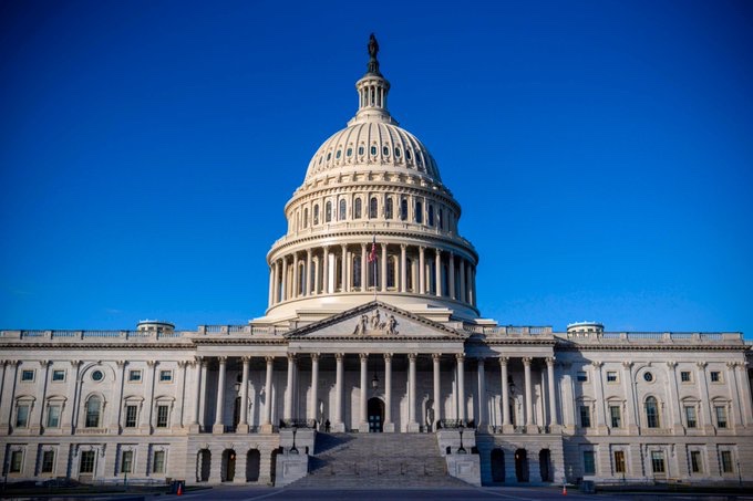 The image shows the U.S. Capitol Building in Washington, D.C., bathed in golden sunlight against a deep blue sky. This iconic symbol of American legislative power connects to the post about the CLARITY Act, as the building represents the very halls of Congress where such financial regulatory legislation would be debated and enacted to bring clarity to XRP's status.