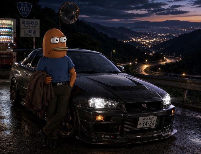 An image showing a character with a potato-like head leaning against a black Nissan GT-R (Skyline R34) at night on a mountain road, with Japanese road signs visible ("道志みち Doshi-michi" and "山梨県 Yamanashi-ken") and city lights in the valley below.