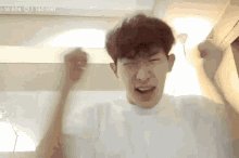 The image features a man with brown hair wearing a white shirt who appears to be making a funny face or gesture, possibly expressing frustration or annoyance. The caption of the image reads "Year 2026: You bought Bitcoin at $69,000 and Ethereum at $1,900, hoping to get rich." This suggests that the man is talking about his experience with cryptocurrency investments in the year 2006.