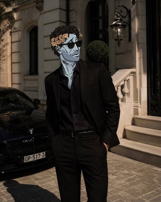 A digitally illustrated or edited image of a man in a black suit and sunglasses standing on a cobblestone street, featuring surreal elements like a golden laurel wreath on his head and blue-tinted skin, with a black car and European-style building behind him.