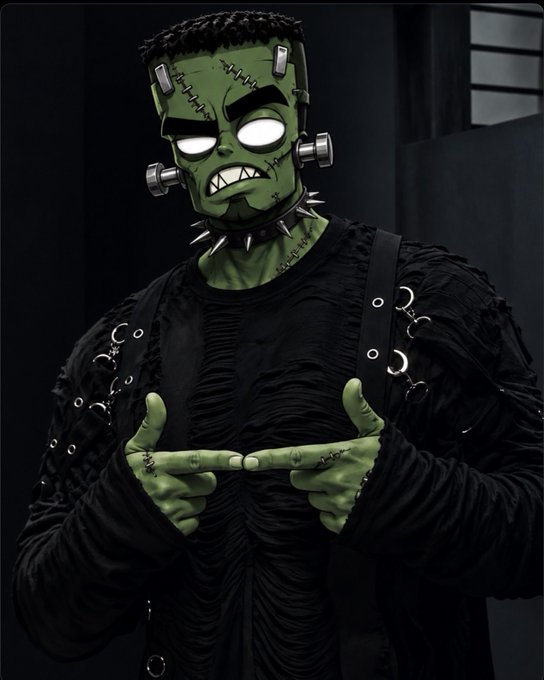 A 3D render of a Frankenstein-like character with green skin, stitches, and bolts, wearing a spiked collar and black clothing, making a finger-gun gesture.