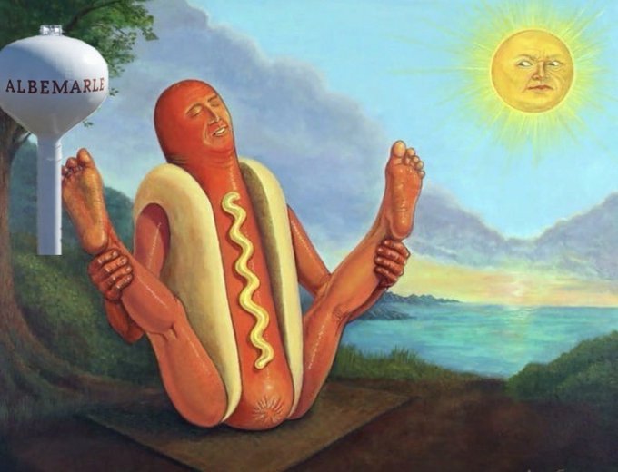 Surreal painting depicting a hot dog character sitting cross-legged in a meditative pose against a landscape, with a personified sun and an Albemarle water tower in the background.