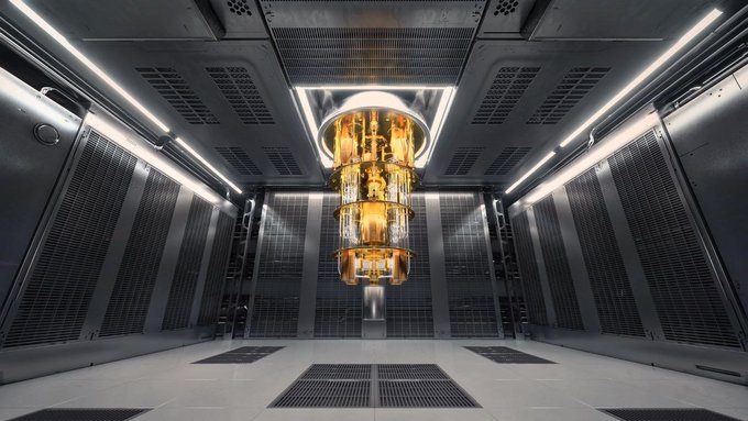 A futuristic, metallic room featuring a glowing golden, multi-tiered chandelier hanging from the ceiling, surrounded by server racks or technical panels with bright white lights.