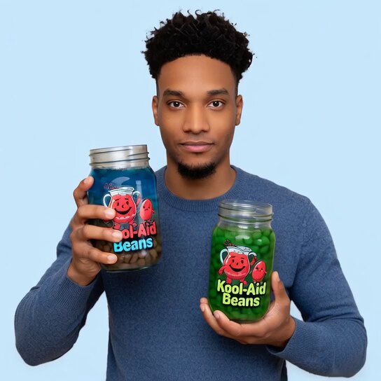 The image features a man holding two jars of Kool-Aid, one green and one red, against a blue background. The caption reads "Ansem got the best koolaid beans on the blockchain Who needs?". This suggests that the man is promoting or celebrating the quality of the Kool-Aid beans he has in his possession.