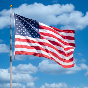 An American flag waves against a partly cloudy sky, symbolizing U.S. legislative action as Senate Republicans introduce a new crypto tax bill to establish clearer federal tax rules for digital assets, including staking, stablecoins, and network fees.