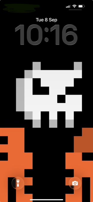 An iPhone lock screen with a pixel art wallpaper depicting the classic Space Invaders alien character in white and orange against a black background, displaying the time 10:16 and date 'Tue 8 Sep'.
