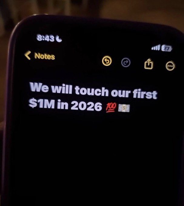 A close-up of a smartphone Notes app showing the bold text "We will touch our first $1M in 2026 💯" at 9:43, reinforcing the motivational "Claim it, Now" affirmation with a specific financial milestone goal.
