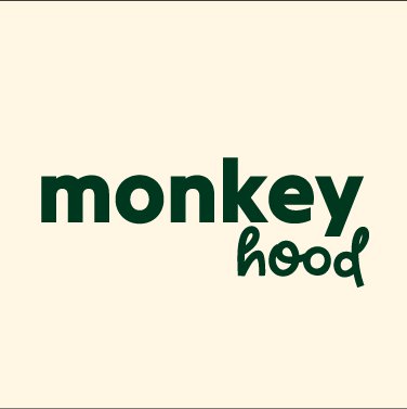 Logo with the text 'monkey hood' in dark green lettering on a cream background.