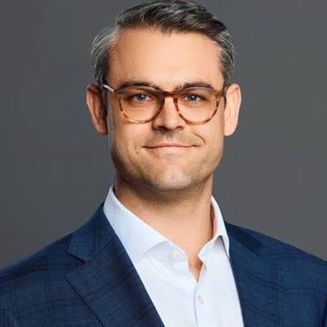 A professional headshot of a man with graying hair and tortoiseshell glasses, wearing a blue suit jacket and white shirt, likely a representative or executive from Bitwise. The image accompanies news of Bitwise's NEAR Protocol ETF approval, suggesting the individual pictured may be associated with the firm's leadership.