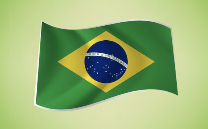 The Brazilian flag, featuring its iconic green field, yellow diamond, and blue globe with the motto "Ordem e Progresso," waves against a light green background—symbolizing Brazil as its central bank announces a 24-hour delay on crypto transfers exceeding $10,000 to combat fraud.