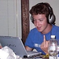 A young man in a blue t-shirt wears large headphones while smiling and giving a thumbs-up at his laptop, which has a "VAIO" logo visible on it. The image illustrates the caption's message about successful people valuing alone time, as the man appears content while working or enjoying media privately with headphones on.