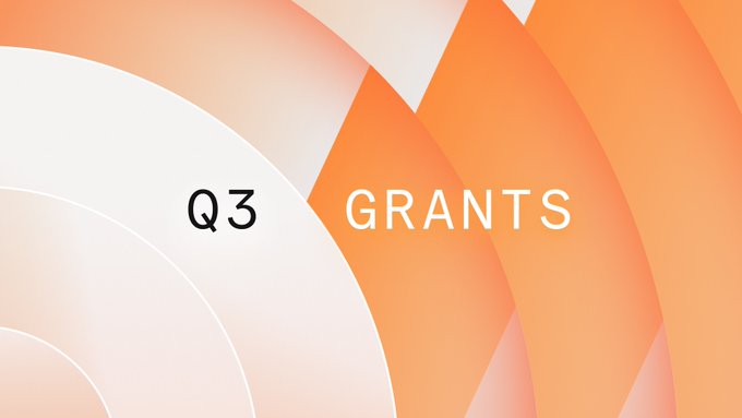 A slide with orange and white geometric wave patterns displaying the text 'Q3 GRANTS'.