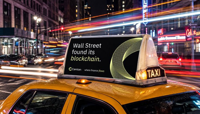 A yellow taxi cab in New York City displays a digital rooftop ad for Canton Network reading "Wall Street found its blockchain" with the tagline "where finance flows," set against a bustling nighttime cityscape streaked with light trails from passing traffic. The image visually reinforces the "3..." post by suggesting momentum or anticipation—perhaps hinting at a countdown or a new development in blockchain's adoption by traditional finance.