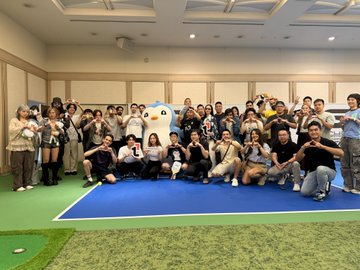 A large group poses together in a rally-themed lounge setting in Tokyo, featuring an "Avax" mascot and PUDGY PENGUINS character, celebrating the WebX Japan side event sponsored by BTSE that combined pickleball, golf simulators, and crypto community networking.