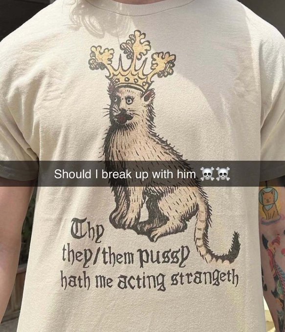 A person wearing a cream-colored t-shirt with an illustration of a crowned cat and the text "Thy they/them pussy hath me acting strangeth," overlaid with an Instagram story text asking "Should I break up with him 💀💀".