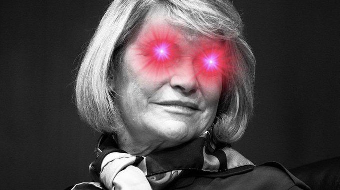 A black and white edited photo of a woman with blonde hair featuring glowing red/pink eyes added as a special effect.