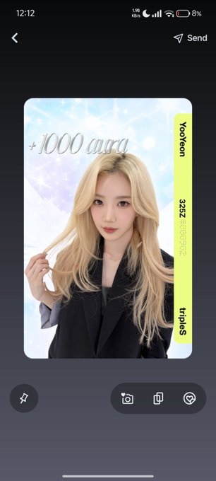 A photo of a blonde woman holding a strand of her hair with the text "+1000 aura" appears on a digital card labeled "Yooyeon," "3252," and "Triples," showcasing one of the user's favorite K-pop collectible objekt cards in response to the request.