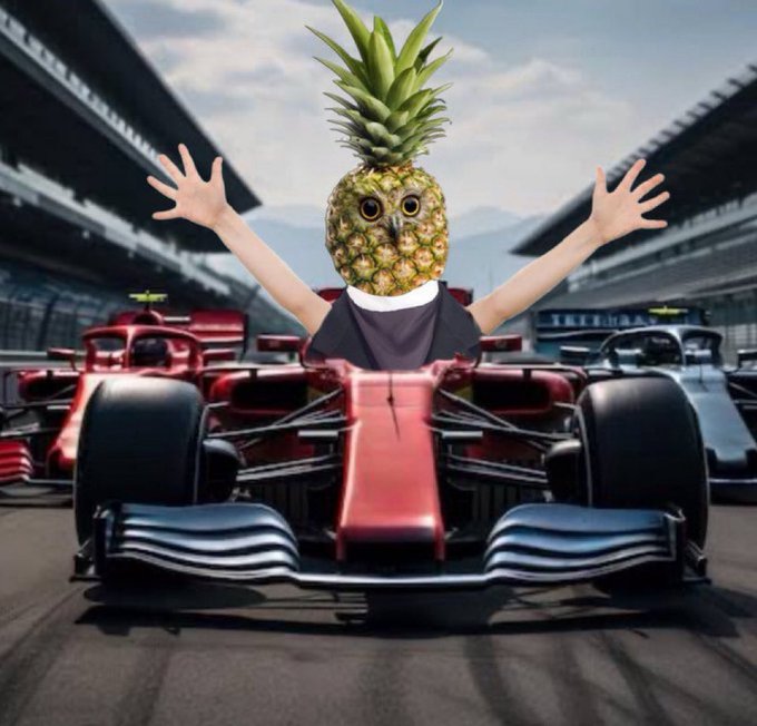 A surreal AI-generated image of a person with a pineapple for a head sitting in a red Formula 1 race car, raising their arms in triumph with other race cars visible in the background.