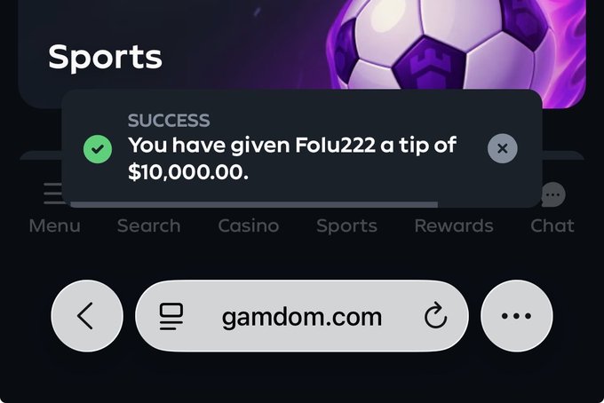 A screenshot from the mobile browser at gamdom.com displays a "SUCCESS" notification confirming a $10,000.00 tip was given to user "Folu222," which ties into the accompanying post celebrating a big win and warning the recipient not to gamble it away.