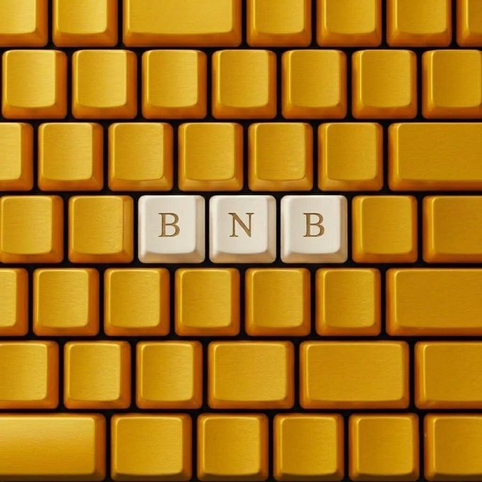A close-up photo of a yellow computer keyboard where three white keys in the center spell out 'BNB'.