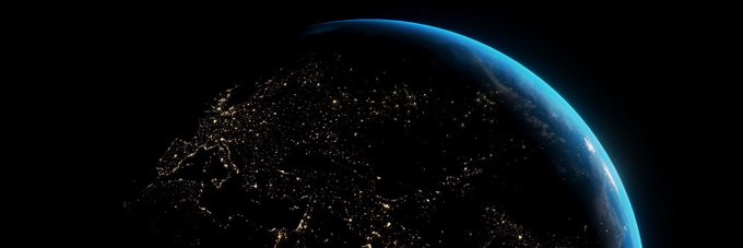 A view of Earth from space at night, with city lights glowing across the dark side and a thin blue atmospheric glow along the horizon against the black void of space. The image evokes the global, planetary scope often used in crypto branding, fitting for $EARTHCOIN's Earth-themed identity as it positions itself within the early Robinhood Chain ecosystem.