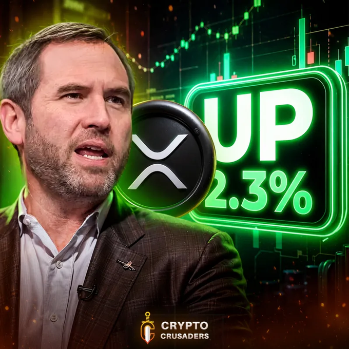 A man speaks next to a graphic showing the XRP logo with 'UP 2.3%' text and a green neon stock chart background, branded as 'CRYPTO CRUSADERS'.