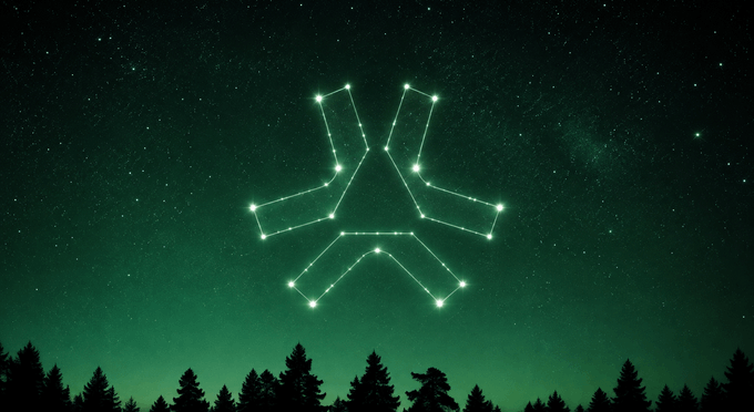 A glowing green constellation shaped like the letter 'X' or a stylized figure shines against a dark, starry night sky above a silhouette of pine trees.