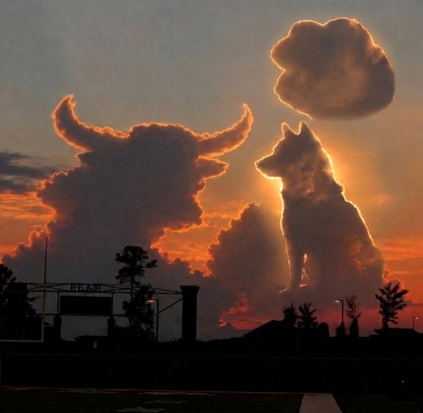 A dramatic sunset photograph shows clouds shaped like a bull's head and a howling wolf, with an "I AM" sign visible in the silhouetted foreground.