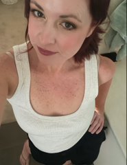 A woman with reddish-brown hair and a white tank top poses indoors, likely sharing a selfie to promote her weekly Twitter Spaces event "shill & chill" where she will host giveaways, games, and NFT promotions. The casual, personal photo complements her friendly morning greeting aimed at engaging the crypto and NFT community.