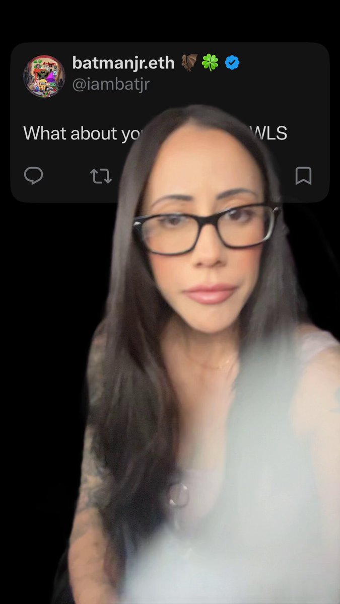 The image features a woman with long hair wearing glasses, who appears to be taking a selfie using her phone's camera. The photo has been edited or filtered, giving it a dreamy or artistic appearance. The caption of the image includes some text about the Cardano community and the Bittrex days.