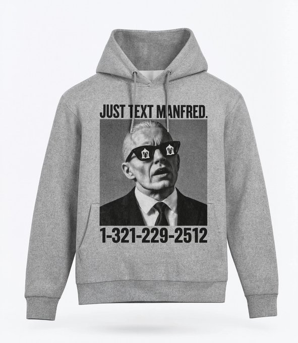 Gray hoodie featuring a black-and-white image of a man in sunglasses with the text 'JUST TEXT MANFRED.' and phone number '1-321-229-2512'.