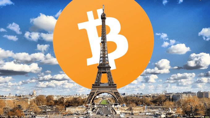 A composite image showing the Eiffel Tower in Paris with a large orange Bitcoin logo superimposed in the sky behind it.
