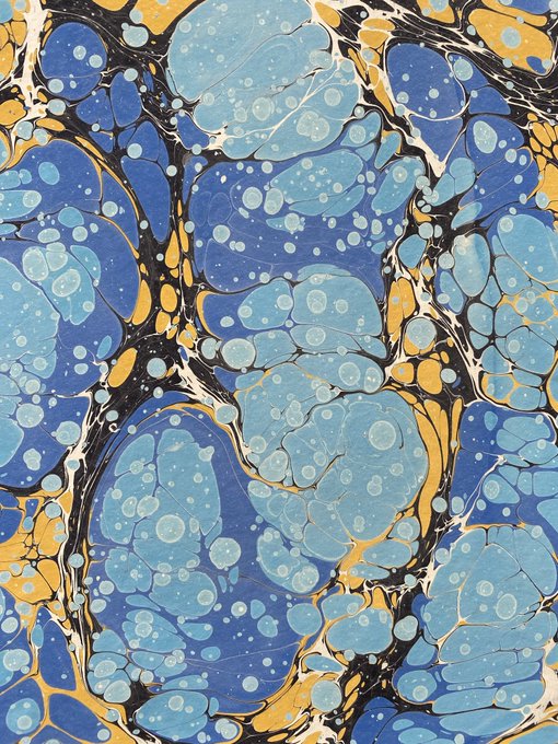 The image features a painting with blue, yellow, and black colors that creates an interesting visual effect resembling bubbles or marbled art. The artwork has a unique texture and appears to be made using a technique called "marbling." The artist's name is also included in the image.