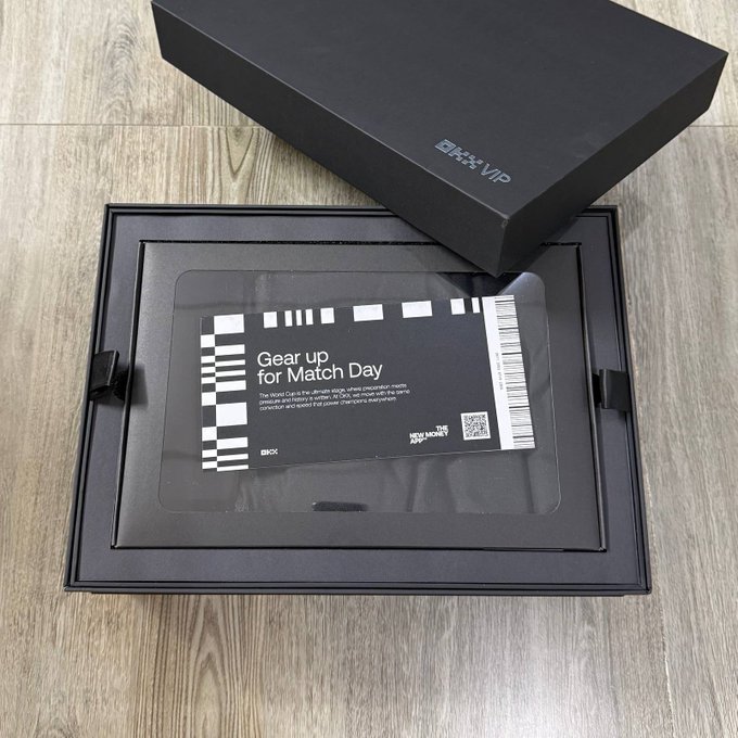 A black box labeled '日本VIP' opened to reveal a slide-out tray containing a card with 'Gear up for Match Day' text, a QR code, and a barcode, branded 'NX MONEY'.