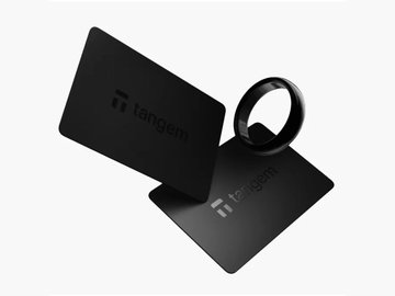 Two black 'Tangem' branded cards with a black ring wallet accessory on a white background.