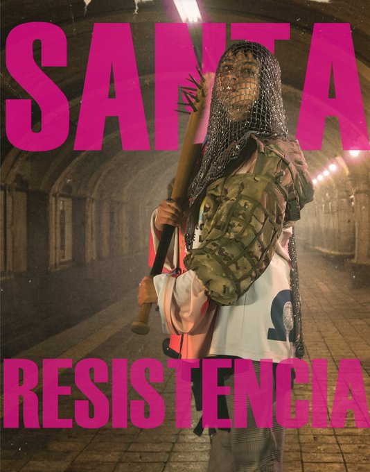 The image features a woman holding a baseball bat, standing inside an underground tunnel or subway station with pink walls. The text "SANTA RESISTENCIA" is written above her head, which could be interpreted as a message related to resistance against authority or societal norms.